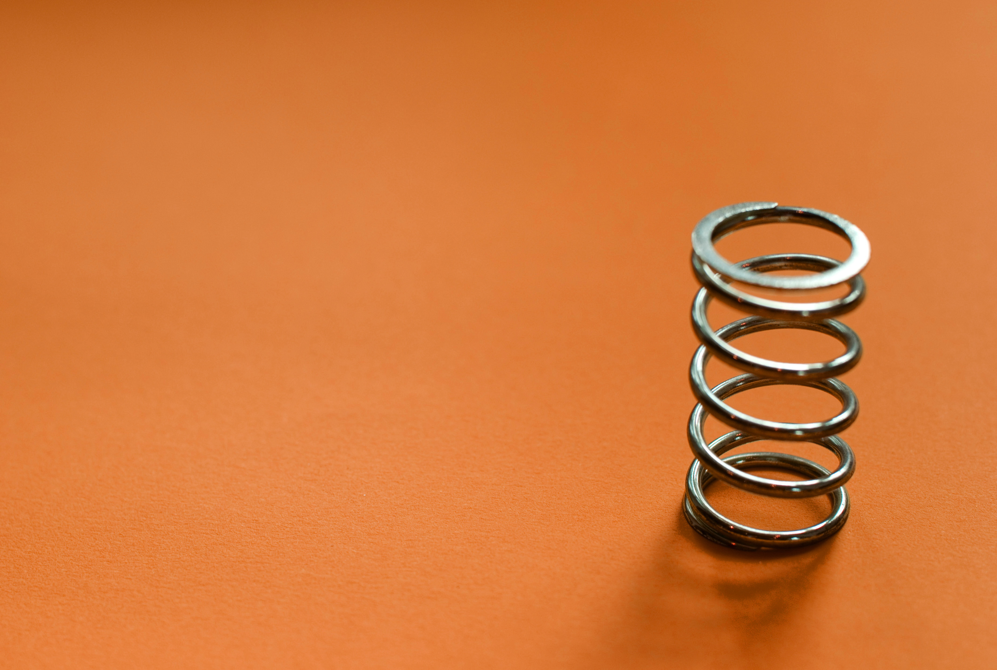 coiled-spring-on-brown-3883-stockarch-free-stock-photo-archive