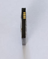 A defective cell phone lithium ion battery which has expanded out of shape