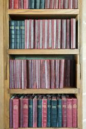 rows of hymn and prayer books on a church bookshelf