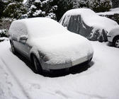 a car covered in a layer of fresh snow