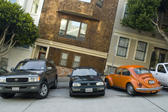 cars parked on one of san franciscos many steep hills photographed to create an unusual visual effect