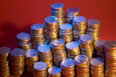 financial independence: stacks of coins lit with a blue light
