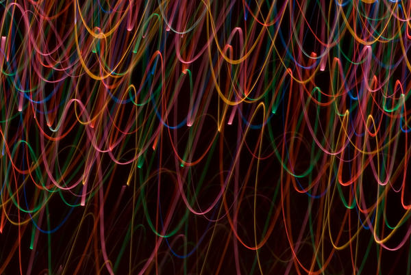 moving lines of light create a festive background of light on a black backdrop