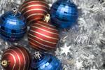 stock image blue and red colored christmas decorations on a silver tinsel backdrop