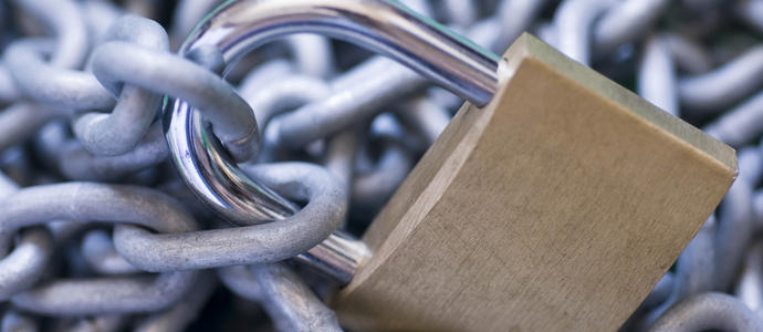 security: chain secured by a locked brass padlock