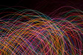 weaving and intertwined curved lines of light on a black background