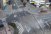 Aerial view of an empty street intersection in central Osaka, Japan showing traffic markings and crossings