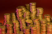 piles of gold coloured coins - concept of rich and wealthy