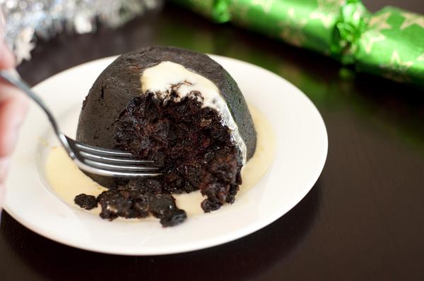 eating a christmas fruit pudding with brandy butter