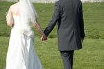 a bride and bridegroom hand in hand after the marriage ceremony
