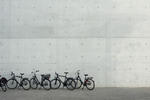 Commuter bicycles parked in a row outside a commercial building as people opt for a cheaper eco-friendly mode of transport