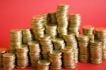 money making concept, a red background with stacks of gold coloured coins